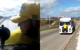 Bolsonarista pendurado em para-brisa de caminhão